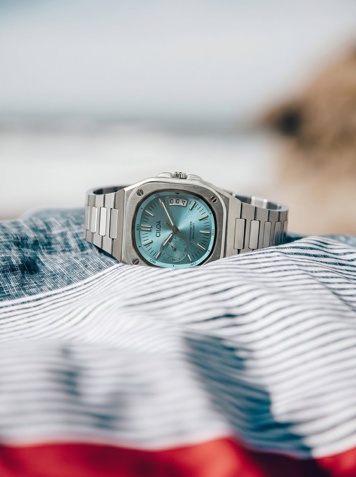 CILOA Marine with stainless steel bracelet by the water